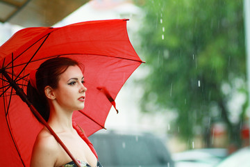 woman holding a red umbrella