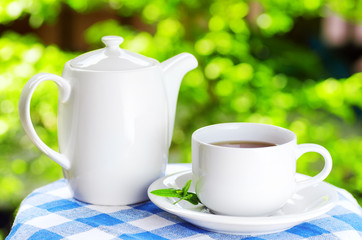 Cup of tea on nature background