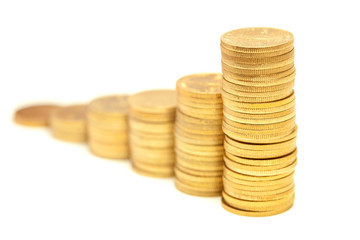 Columns of golden coins isolated on white
