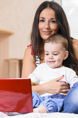 mother and son are using laptop