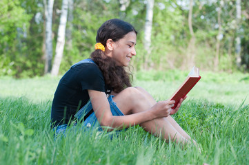Teen girl reading a book on nature