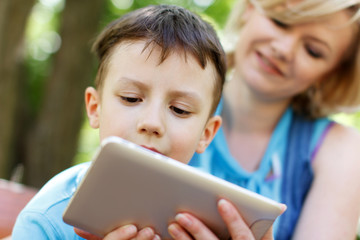 Preschool boy playing on tablet