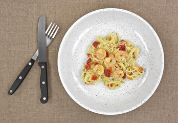 Angel hair pasta with shrimp in shallow bowl