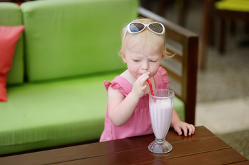 Adorable little girl drinking milkshake © MNStudio