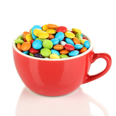 Colorful candies in cup isolated on white