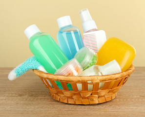 Hotel amenities kit on table on beige background