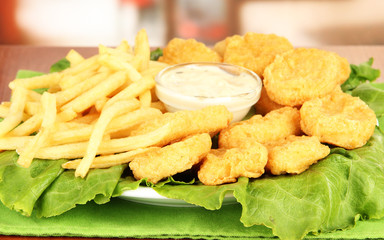Fried chicken nuggets with french fries and sauce