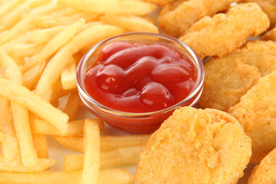 Fried chicken nuggets with french fries and sauce isolated