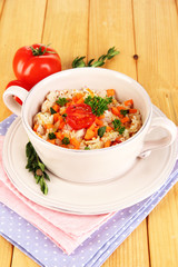 Delicious rice with vegetables and herbs in pot