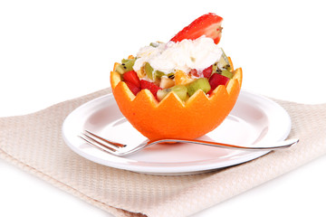 Fruit salad in hollowed-out orange isolated on white