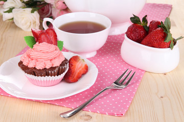 Beautiful strawberry cupcake and flavored tea