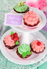 Delicious beautiful  cupcakes on festive table close-up