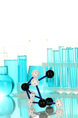 Molecule model and test tubes with blue liquids isolated