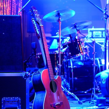 Guitar and other musical equipment on stage before concert