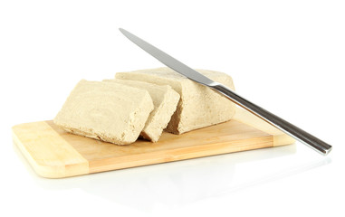 Tasty halva on cutting board isolated on white