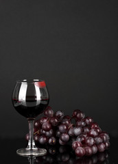 Glass of wine with lipstick imprint on dark background