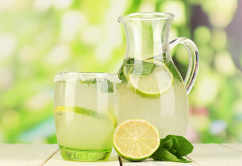 Citrus lemonade in pitcher and glass - obrazy, fototapety, plakaty