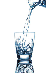 pouring water on a glass on white background..