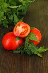 Fresh tomatoes on wooden table close-up