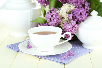 Composition with beautiful lilac flowers, tea service