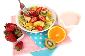 Useful fruit salad of fresh fruits and berries in bowl isolated
