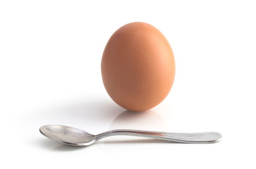 Fototapeta na wymiar egg and spoon on white background