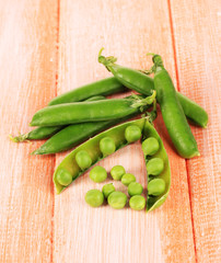 Sweet green peas on wooden background