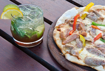 The pizza on the wooden plate