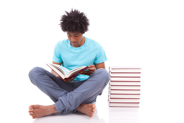 Young black teenage student men reading a books - African people