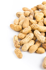 A pile of shelled big peanuts closeup on white background