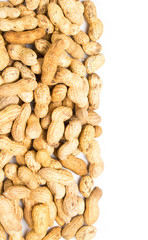Fototapeta premium A pile of raw shelled big peanuts closeup on white background