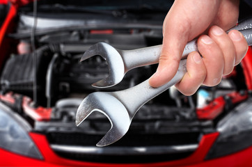 Hand with wrench. Auto mechanic.