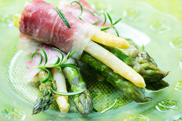 Fresh young asparagus wrapped in Prosciutto ham - obrazy, fototapety, plakaty