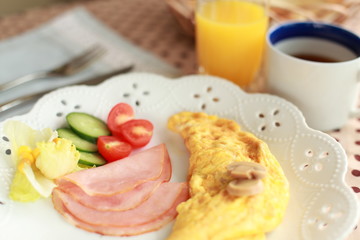 gourmet breakfast, mushroom omelette and ham with salad