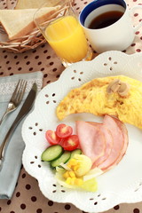 gourmet breakfast, mushroom omelette and ham with salad