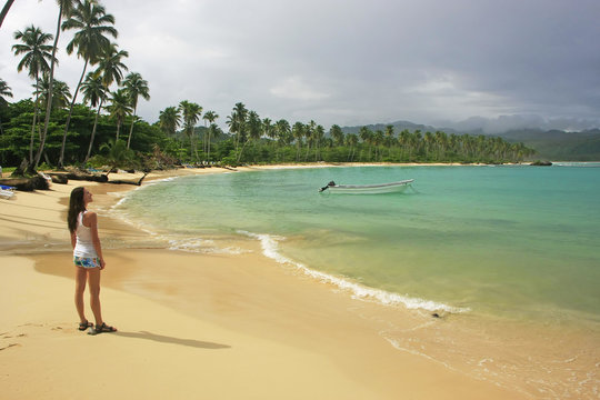 Young woman standing at Rincon beach, Samana peninsula