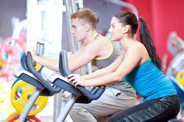People in the gym doing cardio cycling training