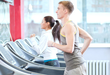 Fototapeta premium Woman and man at the gym exercising