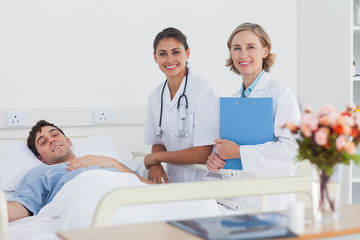 Fototapeta premium Two doctors and a patient looking at the camera