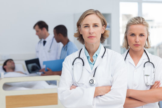 Two serious women doctors standing
