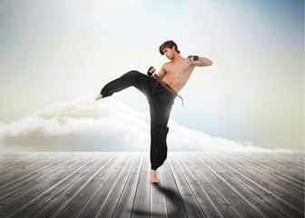 Martial arts fighter over wooden boards