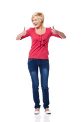 Beautiful blonde woman showing thumbs up