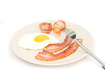 Bacon ham egg and green salad on dish isolated on white