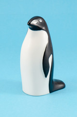 toy penguin figurine home decor on blue background