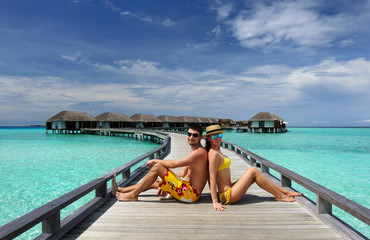 Couple on a beach jetty at Maldives