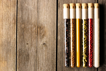 Spices in beakers on wooden table