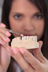 Young woman doctor working in dental prosthesis