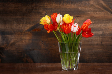 bunch of tulips in glass vase