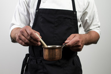 chef holding copper pan