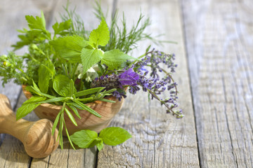 Fresh herbs and spices on vintage wooden boards closeup